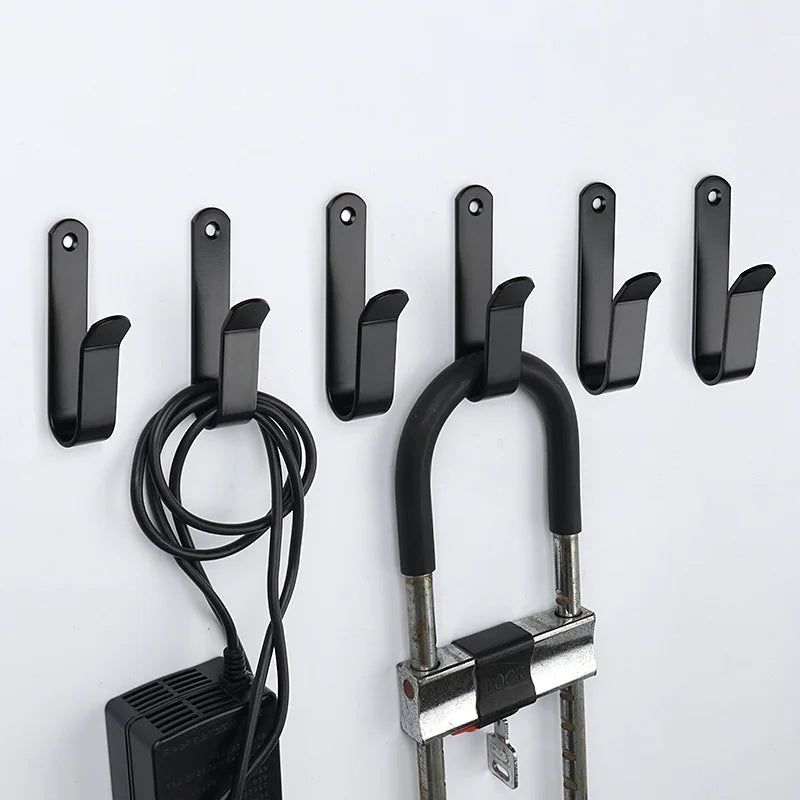 Black snowboard wall mount clips with screws and a coiled cord for mounting equipment