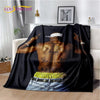 A black throw blanket featuring a graphic design of an artist's back with tattoos and gold chains.