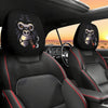 Two black car headrest covers featuring stylized monkey eyes are shown in a vehicle interior.