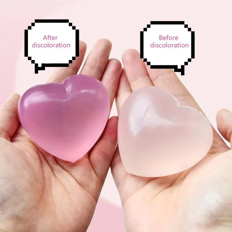 A pink maltose stress relief squeeze toy is shown in two states: after and before discoloration, held in a person's hand.