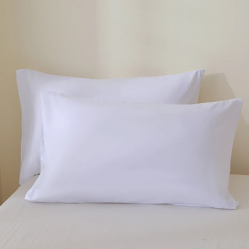 A set of three white premium brushed fabric pillow covers resting on a white surface.