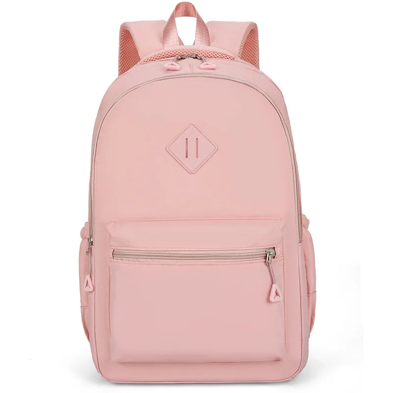 A pink urban nylon backpack with a padded shoulder strap and zippered compartments.