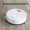 A white robot vacuum cleaner is shown on a wooden floor, ready for cleaning.