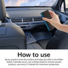 A hand is spraying a car interior detail polishing cleaner onto a surface inside a car dashboard.