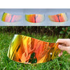 A motorcycle helmet visor lens shield featuring an iridescent, colorful, abstract design shown in multiple angles and in use.