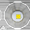 A close-up view of an LED flood light pod, showing the light element and surrounding textured housing.