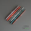 A collection of Uni ZENTO Quick-Dry Gel Pens in various shades of pink, red, and blue are arranged diagonally on a gray surfa