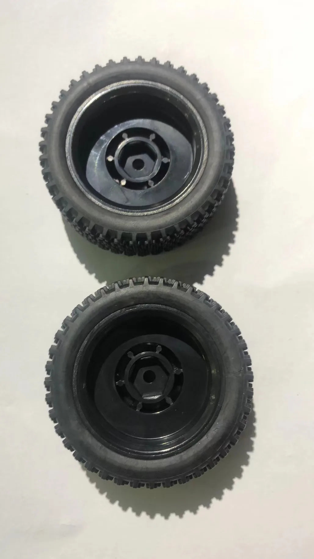 Two black plastic gear or pulley components for a High-Speed 1/16 4WD RC Car Receiver Parts Kit
