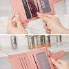 A pink crocodile-embossed PU leather bifold wallet is shown being held by a hand, displaying various compartments and a VIP c