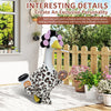 A decorative ceramic goose wearing a leopard print outfit and accessories standing near a wooden fence.