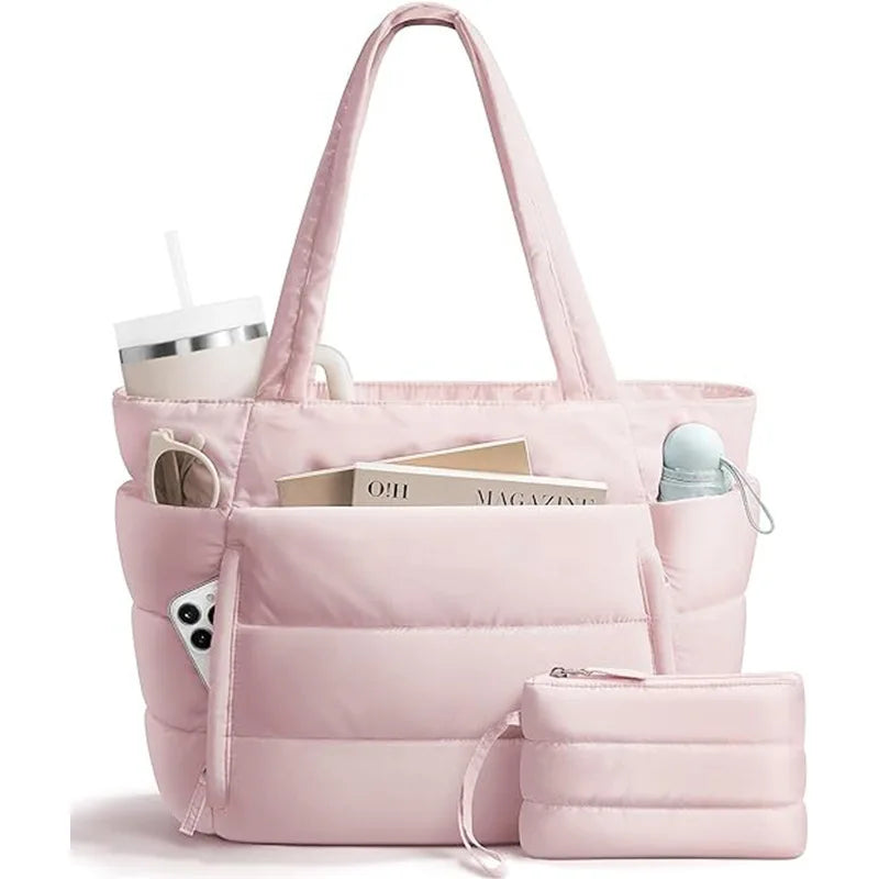 A pink quilted multi-compartment tote bag with a white cup and magazines visible.
