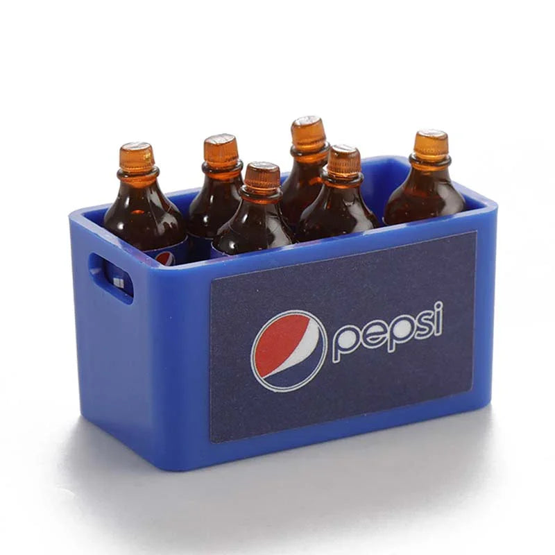 A blue plastic container holding three small glass bottles with orange caps, used as decorative accessories for an RC car.