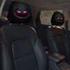 A pair of black car headrest covers featuring creepy purple smiling face designs.