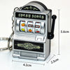 A silver mini fruit slot machine keychain with a black plunger and a rectangular body.