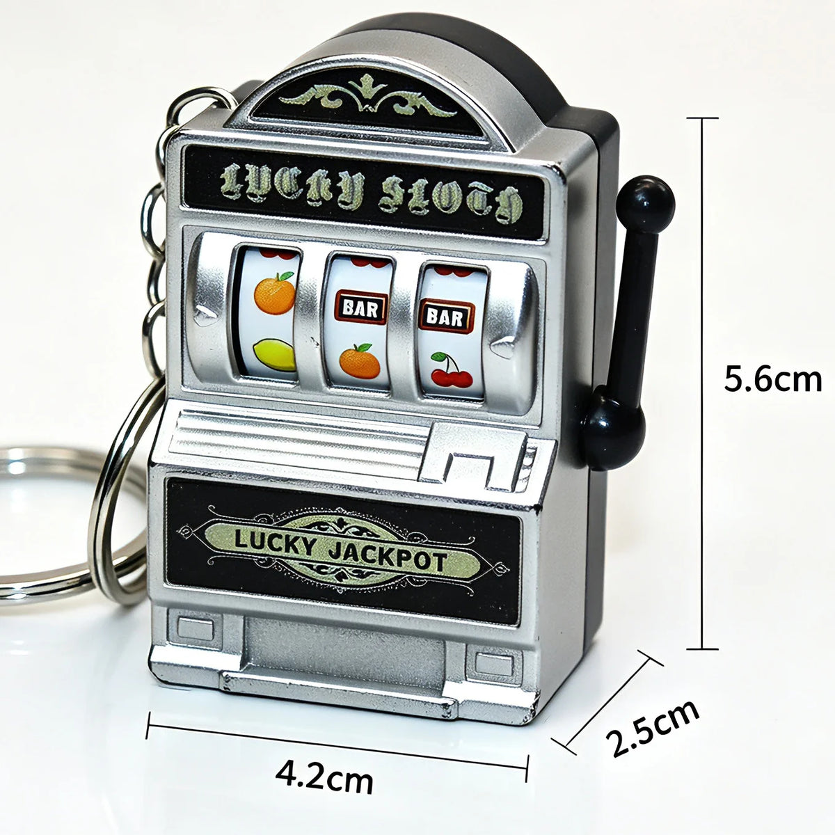 A silver mini fruit slot machine keychain with a black plunger and a rectangular body.