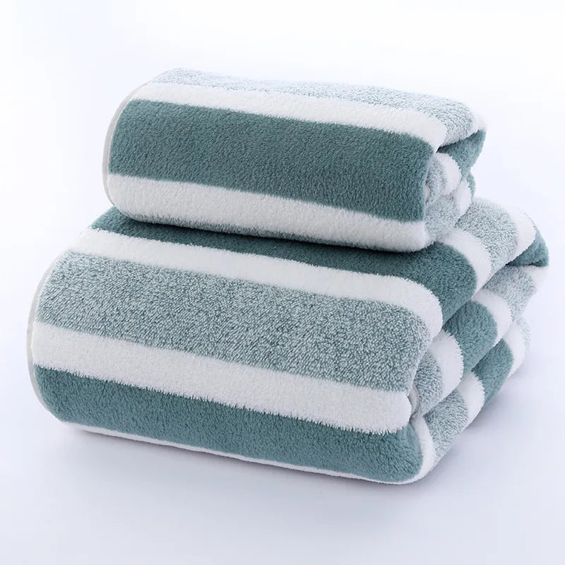 A stack of striped microfiber towels in shades of gray and white.