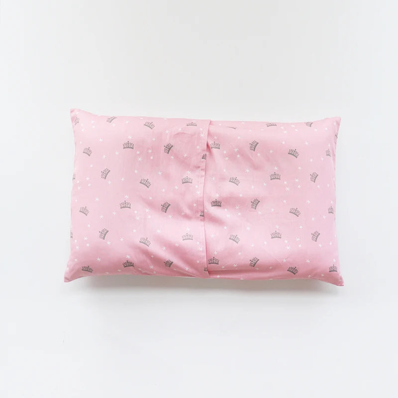 A pink soft cotton baby pillowcase featuring a pattern of small crowns.