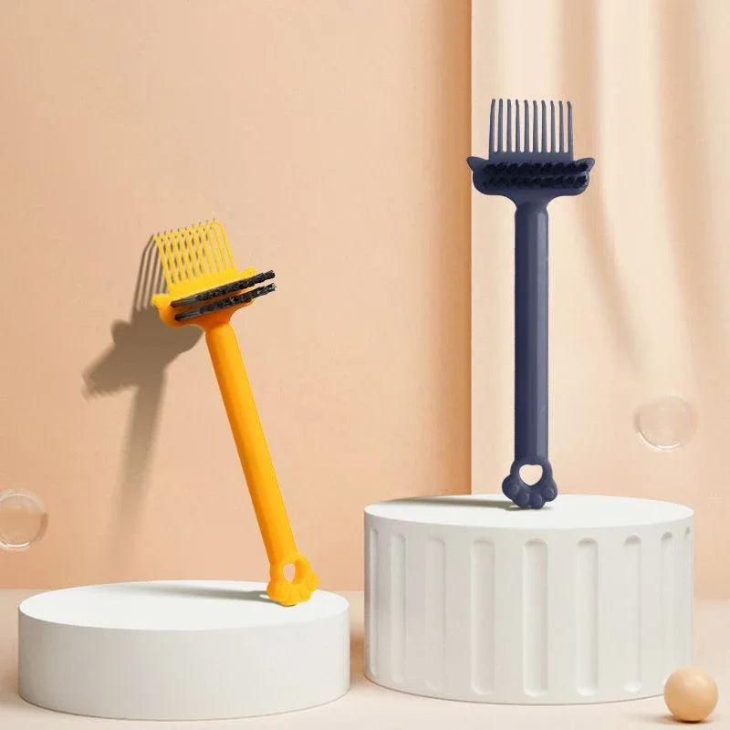 A blue dual-sided hairbrush cleaner with rake teeth is displayed on a white stand against a light background.