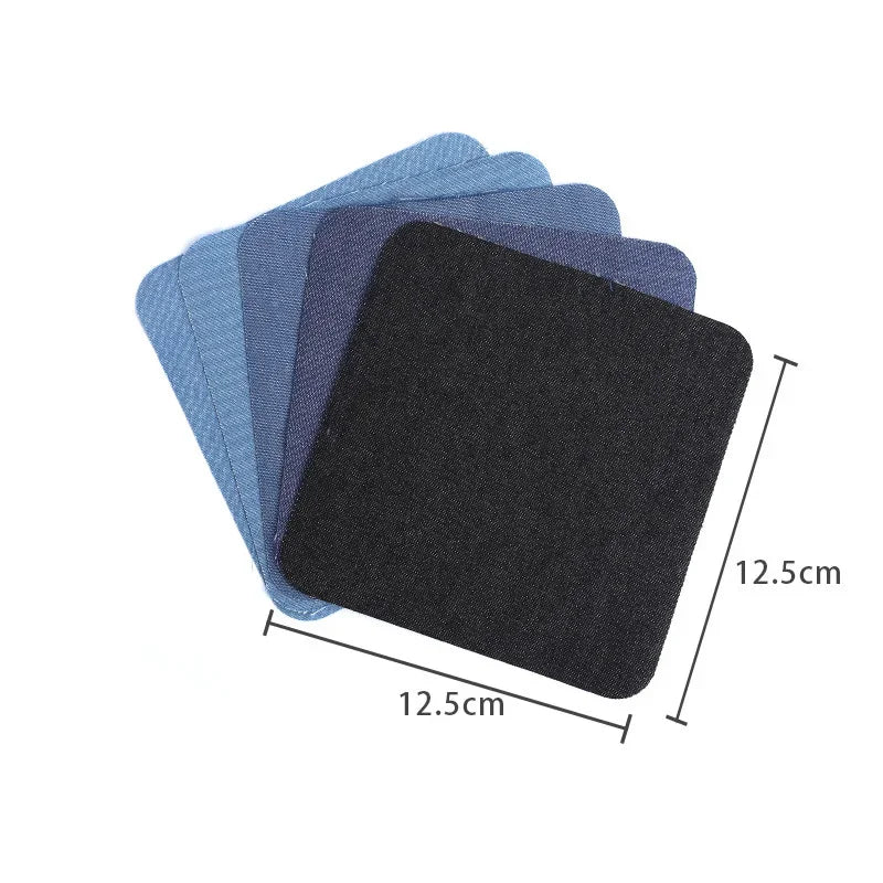 A stack of dark blue and gray iron-on patches for denim repair and decoration.