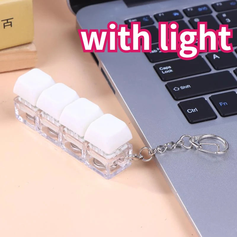 A clear plastic keychain featuring white LED mechanical keycaps attached to a silver chain.