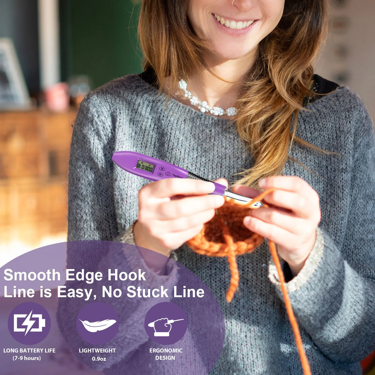 A woman holds a purple LED crochet hook with a smooth edge line against a gray sweater.
