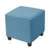 A square ottoman slipcover in a light blue color with a diamond lattice pattern.