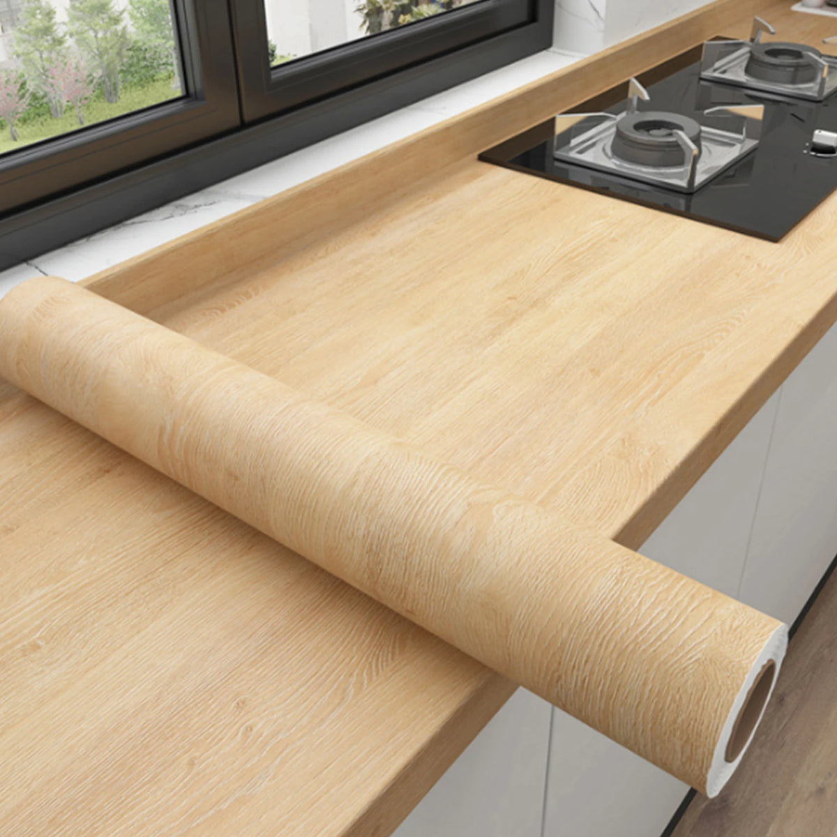 A roll of self-adhesive wood grain wallpaper lying on a light wooden countertop.