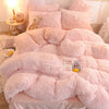 A pink plush mink velvet duvet cover set with sheets displayed on a bed.