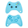 A light blue silicone baby teether toy shaped like a remote control, featuring buttons and holes.