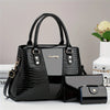 Schwarze Krokodilmuster-Patentlederhandtasche mit goldfarbenen Hardware