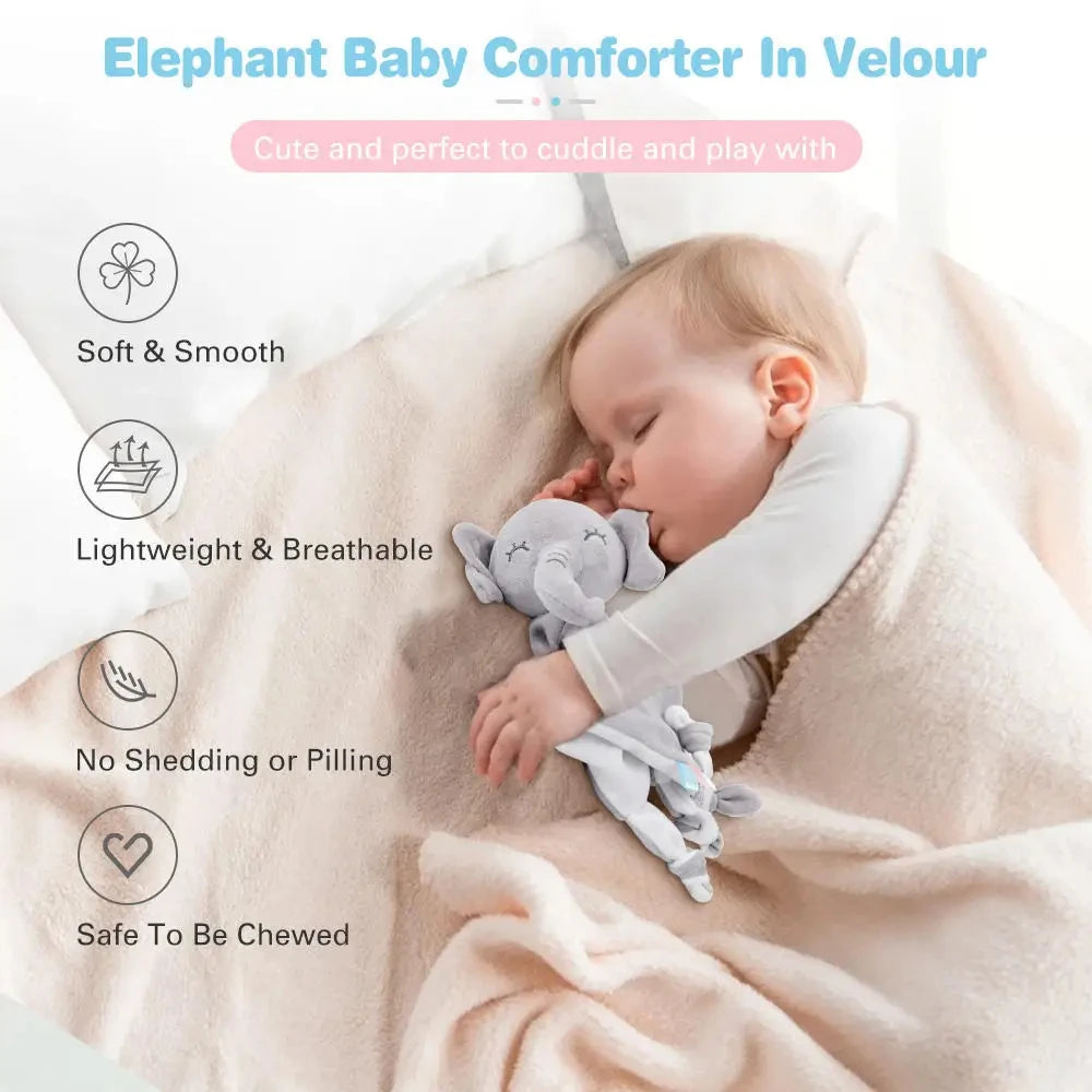 A baby is sleeping comfortably wrapped in a soft velour elephant baby comforter and plush toy.