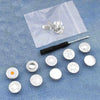 A silver instant no-sew snap button kit for loose jeans is displayed on a blue denim background.