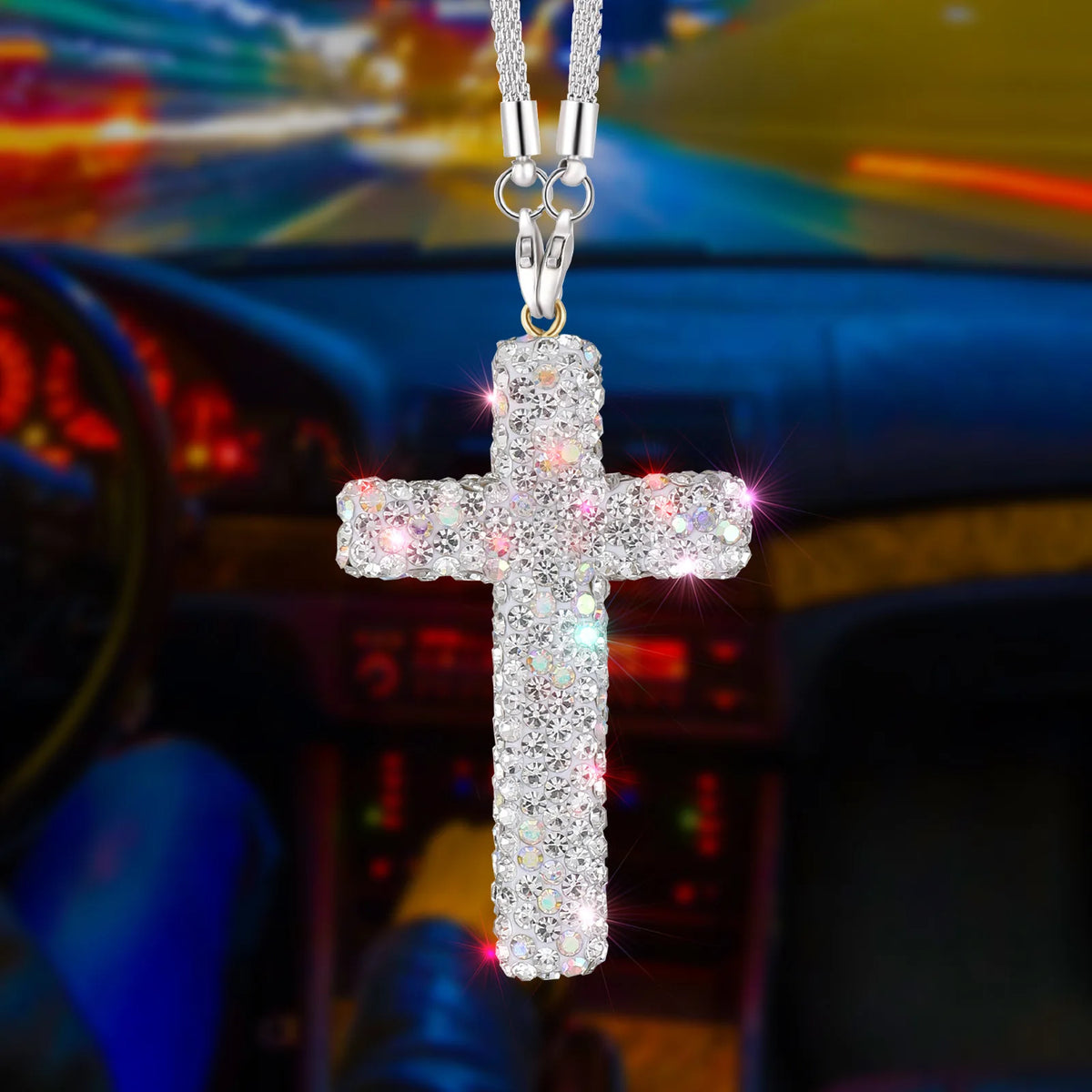 A silver stainless steel cross pendant adorned with sparkling rhinestones hanging from a chain.