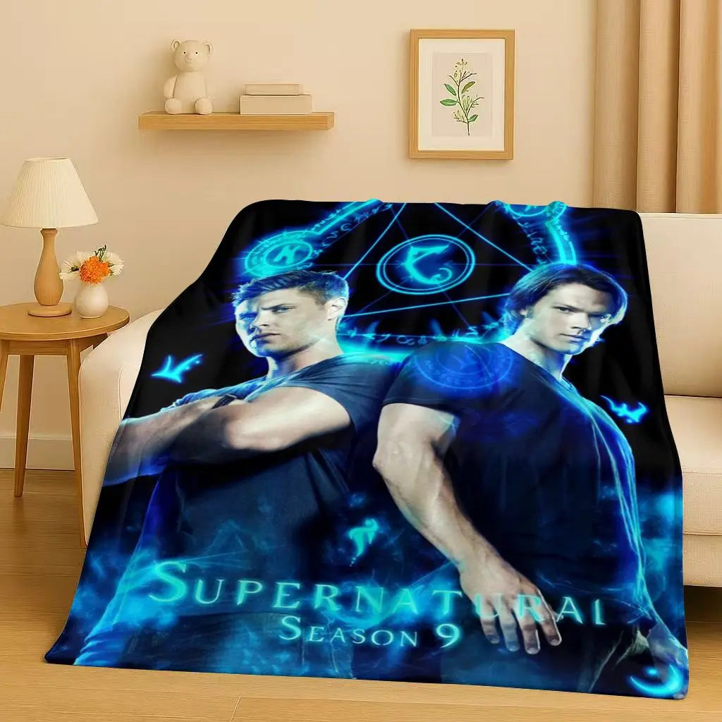 A dark blue and teal themed blanket featuring characters from Supernatural Season 9