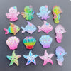 A collection of colorful, iridescent resin charms shaped like sea creatures and starfish for crafting.