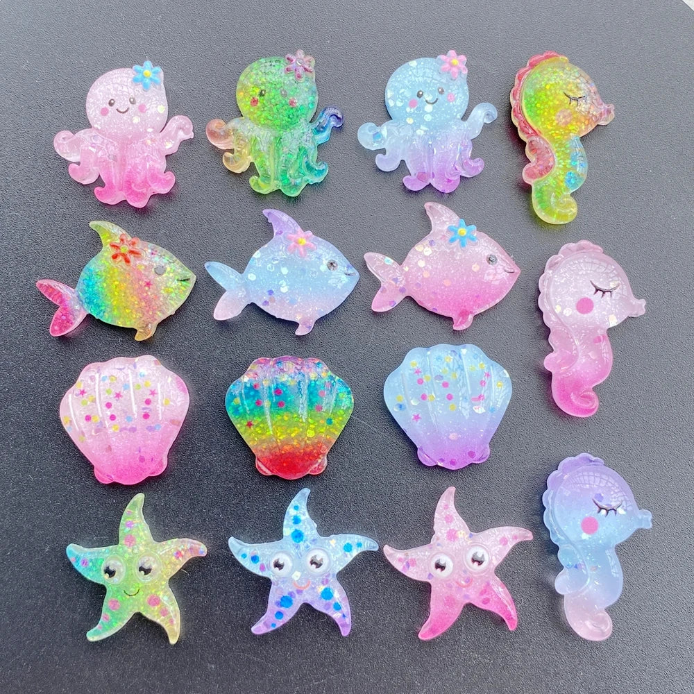 A collection of colorful, iridescent resin charms shaped like sea creatures and starfish for crafting.