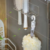 Wall-mounted acrylic organizer holding white hairbrushes and combs on a gray tiled wall.