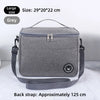 A grey thermal insulated lunch bag with a black adjustable shoulder strap is shown on a white surface.
