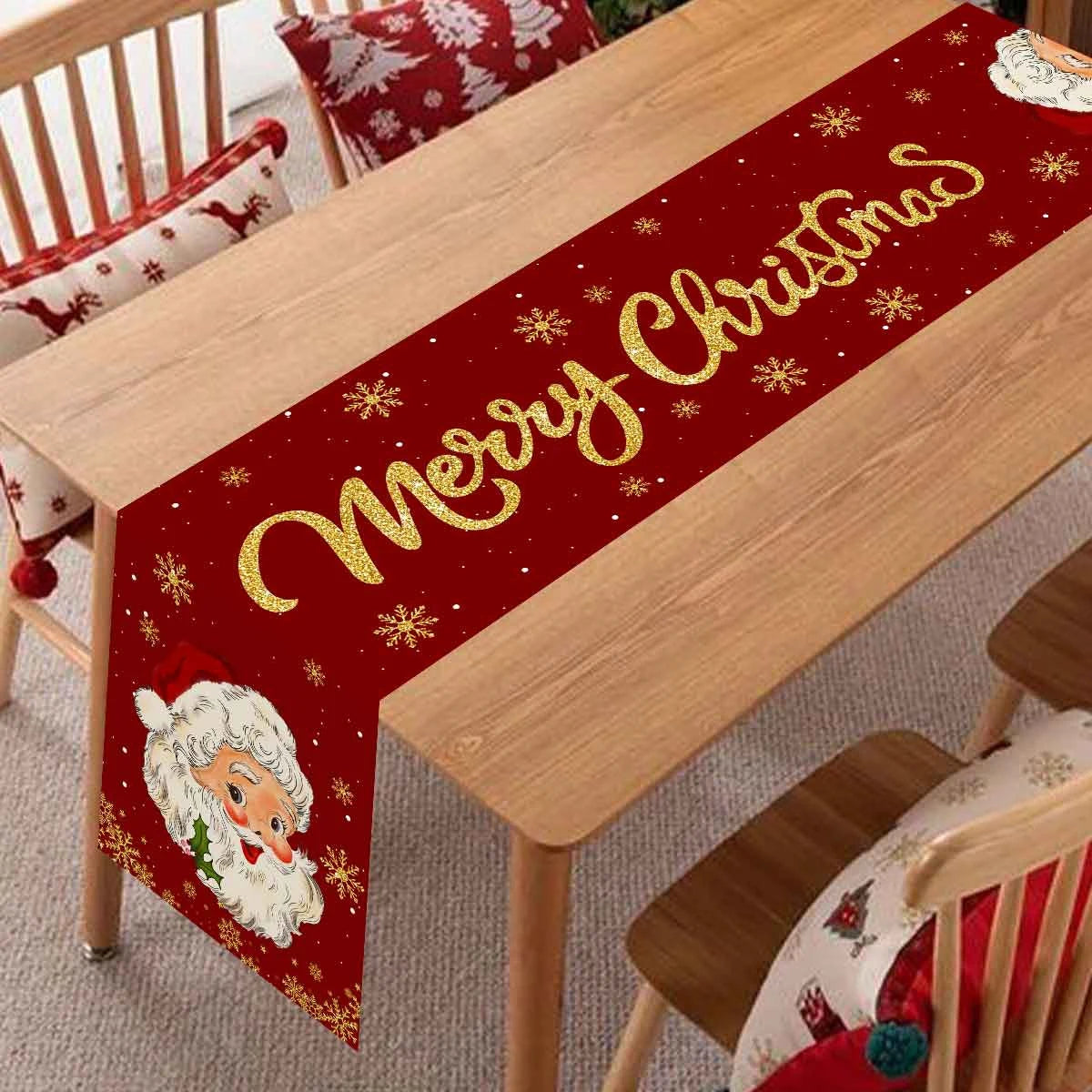 A festive red table runner with gold sparkling text reads Merry Christmas and features scattered gold snowflakes.