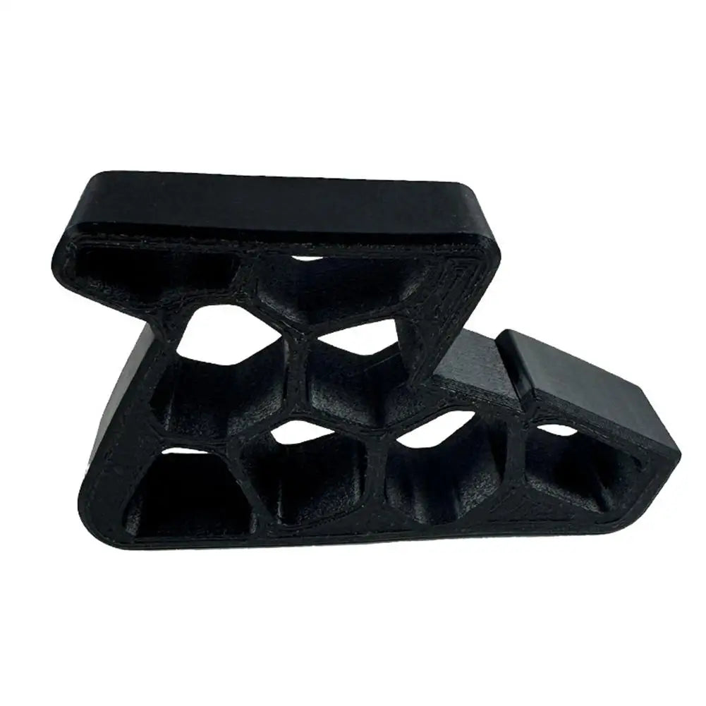 Black heavy-duty non-slip door stopper wedge with a textured, multi-faceted design.