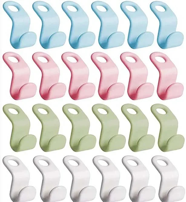 A collection of pink and light blue cascading clothes hanger connector hooks for wardrobe organization.
