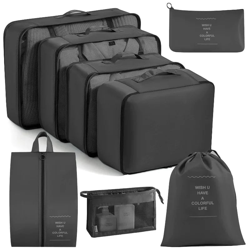 A set of black travel packing cubes and storage organizer bags for clothing.