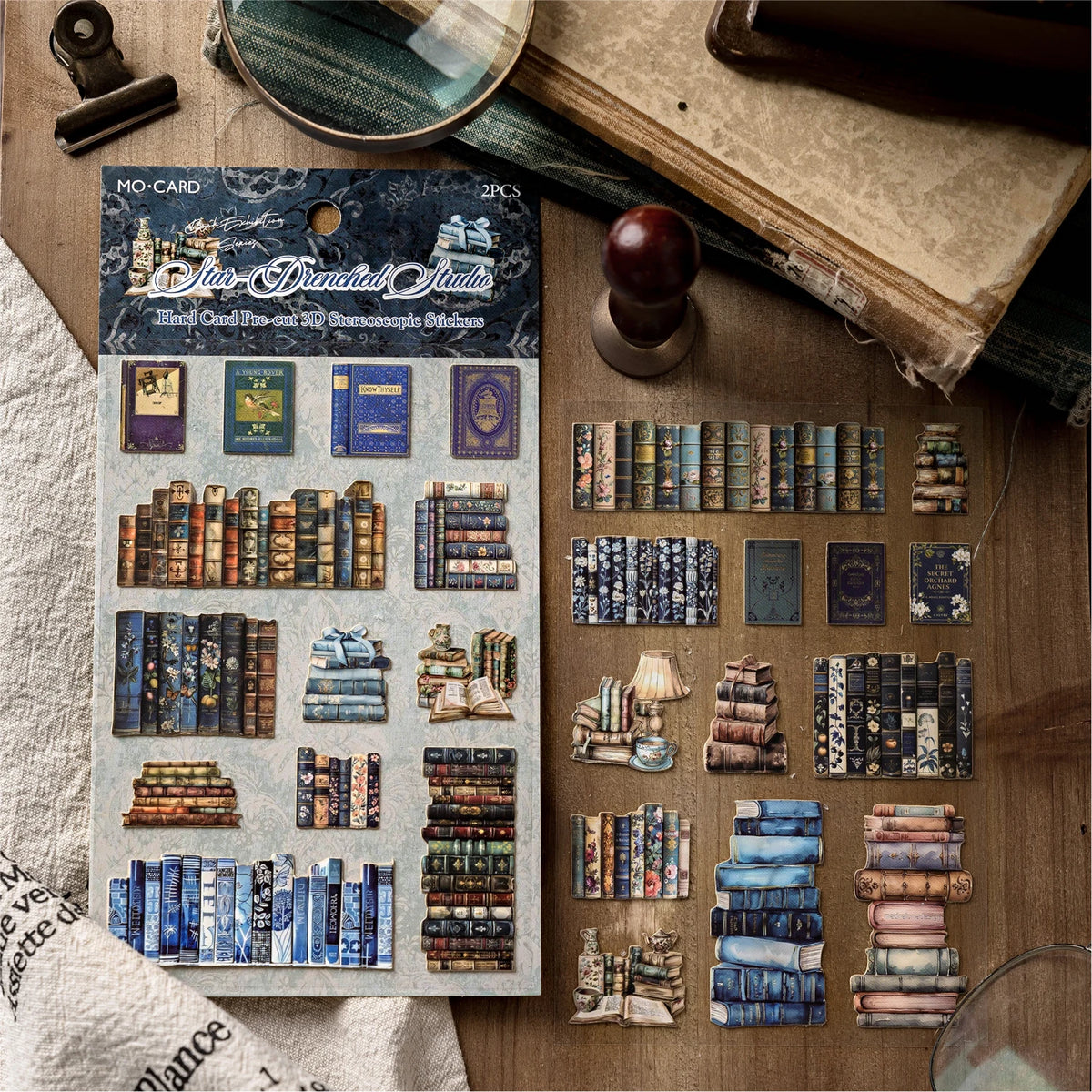 A sheet of MO-CARD stickers featuring vintage book illustrations and textures for journaling and scrapbooking