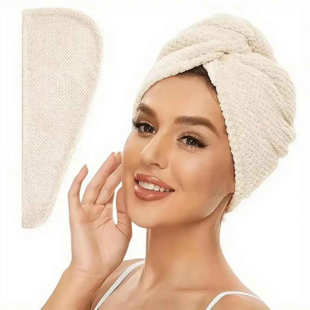A woman is wearing a beige microfiber hair drying towel wrap on her head.