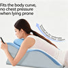 A woman is lying prone on a blue memory foam wedge pillow, demonstrating its fit for the body curve and providing chest suppo