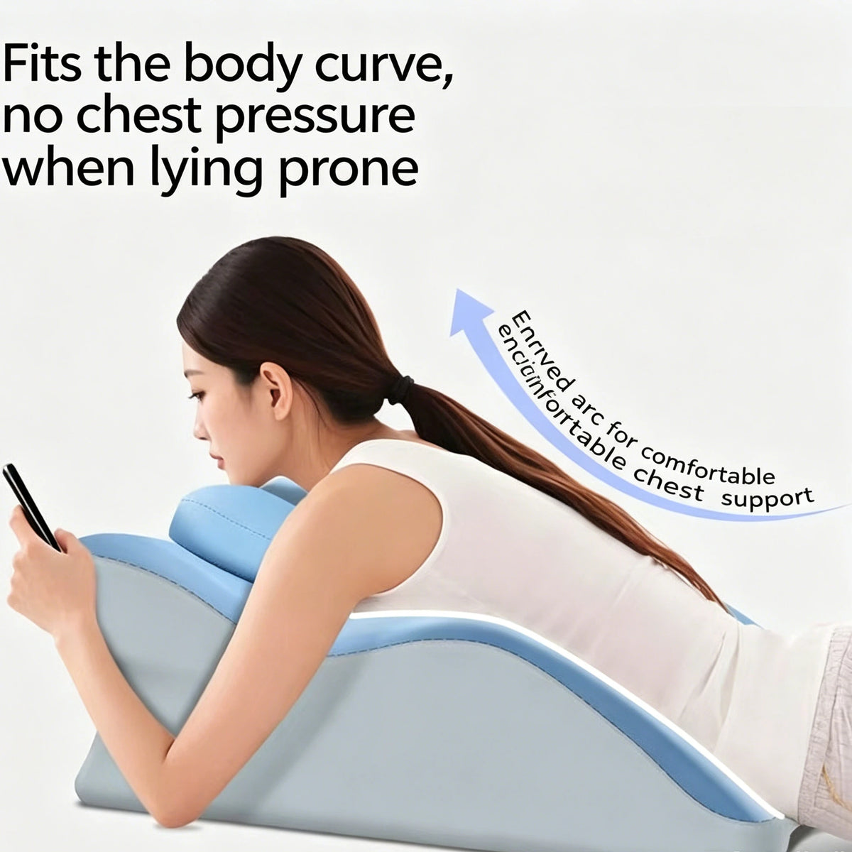 A woman is lying prone on a blue memory foam wedge pillow, demonstrating its fit for the body curve and providing chest suppo