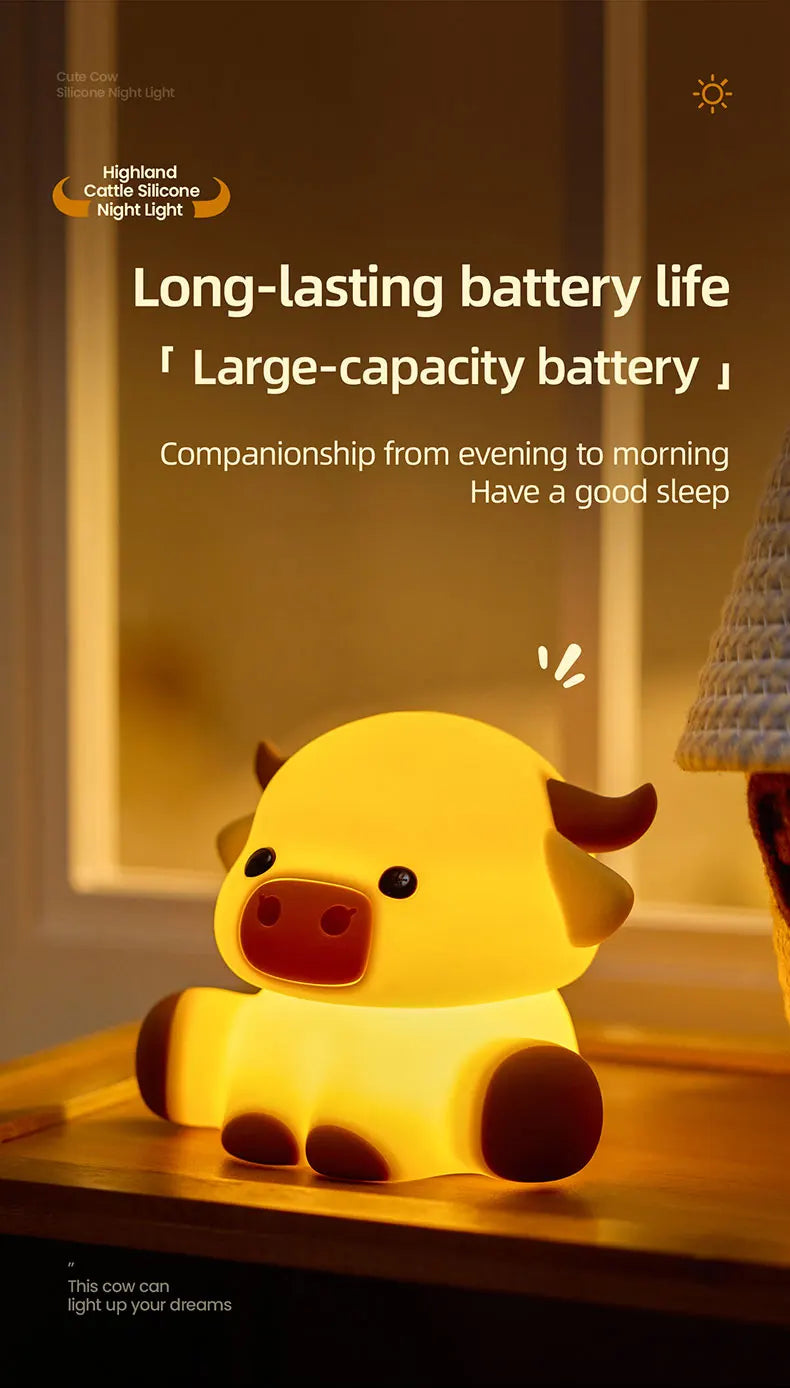 A yellow silicone night light shaped like a pig sitting on a wooden surface.