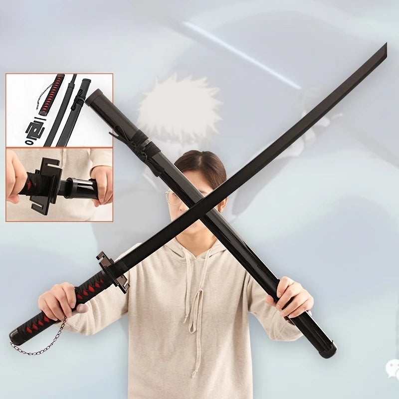 A person holds a black wooden katana replica sword with a chain, demonstrating the product.