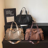 A display of three leopard print bags, including a black faux fur bag, a beige leather bag, and a brown leather bag.