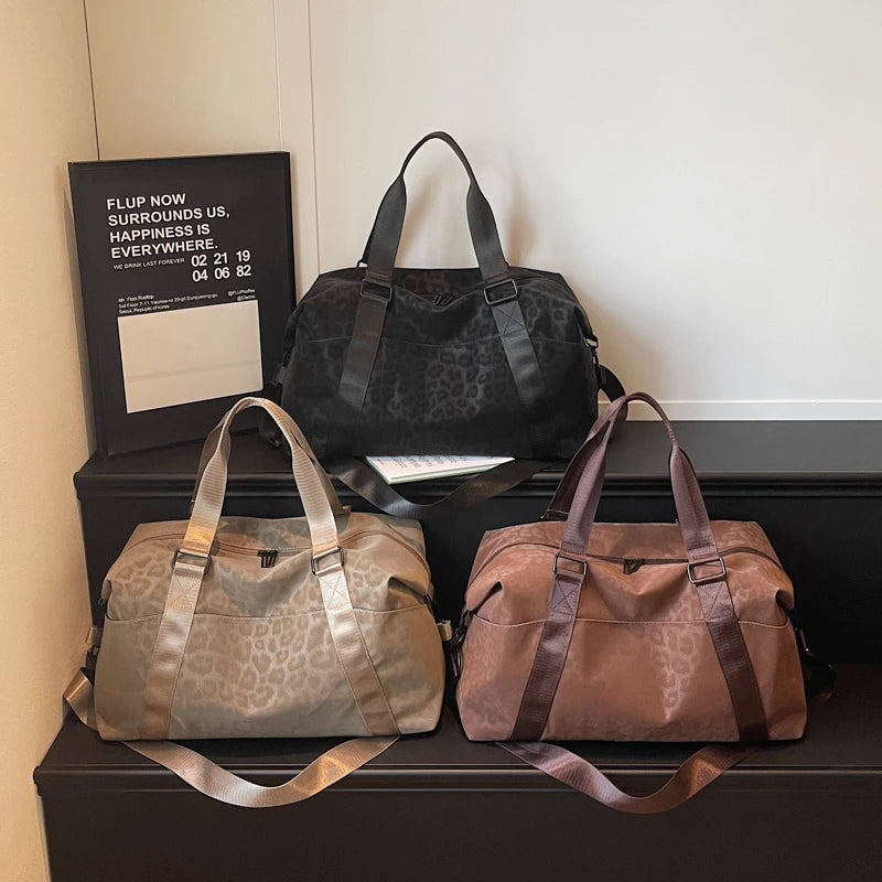 A display of three leopard print bags, including a black faux fur bag, a beige leather bag, and a brown leather bag.